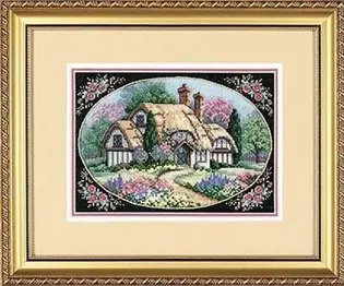 Готова вишита картина хрестиком за набором Dimensions 06710 "Enchanted Cottage" (Зачарований котедж). Мальовничий сільський будиночок із солом'яним дахом серед квітучого весняного саду, оформлений у вигляді овальної віньєтки на чорному тлі з рожевими трояндами по кутах. Робота виконана технікою лічильного хреста на чорній канві Aida 18 та оформлена в класичну золоту раму зі світлим паспарту.